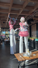 Stilt performers entertain Moscow venue visitors on sunny afternoon