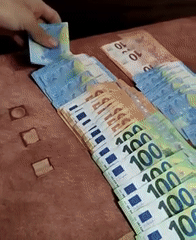 Person arranges Euro banknotes in Yambol, Bulgaria
