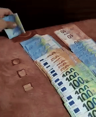 Person arranges Euro banknotes in Yambol, Bulgaria