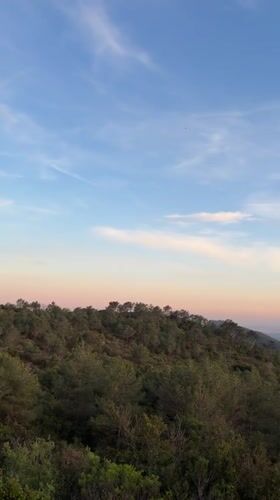 Sunset observed over green hills in Estivella, Spain