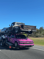 Car hauler transports vehicles on highway near White Springs