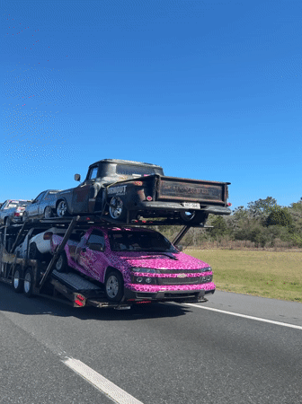 Car hauler transports vehicles on highway near White Springs