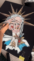 Artist paints crowned woman portrait on black canvas in Krasnoyarsk