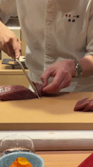 Chef prepares fresh tuna sashimi at historic Tokyo establishment