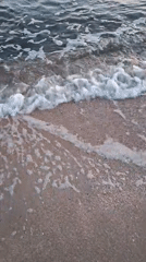Peaceful beach waves documented during sunset hours