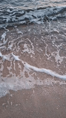 Peaceful beach waves documented during sunset hours
