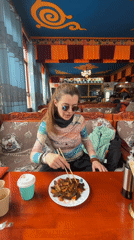 Woman dines at ornate Tibetan restaurant in Jila, China