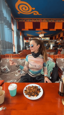 Woman dines at ornate Tibetan restaurant in Jila, China