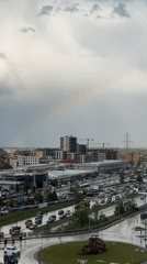 Rainbow appears over Sofia during cloudy afternoon conditions