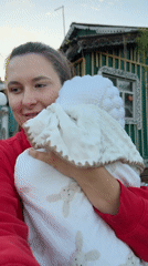 New baby and a toddler spend an evening outside in rural Russia