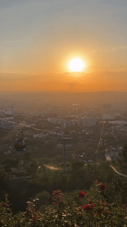 Sunset over Almaty, city skyline and mountains in view
