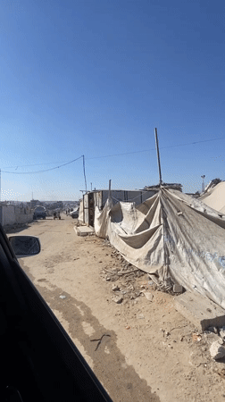 Gaza street scenes with makeshift structures and filming setup