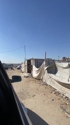 Gaza street scenes with makeshift structures and filming setup