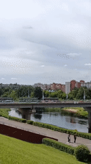 Vitsebsk riverfront, amusement park, and city monument on a June morning