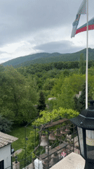 Visitor documents Bulgarian monastery grounds, buildings, cats, mountain views