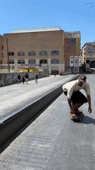 Skaters session a sunny Barcelona plaza on a June morning