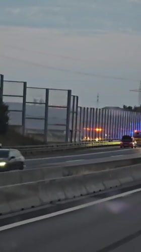 Emergency response vehicles line a German highway at dusk