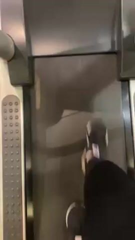 The video shows the first person perspective of someone walking on a treadmill. They are wearing black athletic pants and black sneakers with white soles. The treadmill is light gray and black. The person walking is speaking, mentioning sending a code for someone to unfreeze their credit.