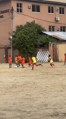Pickup soccer on a dirt field in Ado, Nigeria