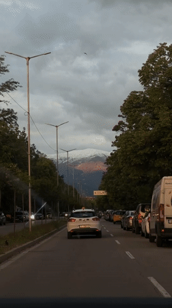Evening street scene captured in Blagoevgrad with mountain backdrop