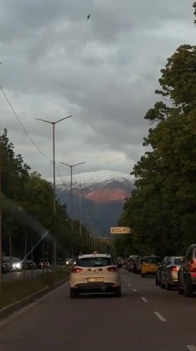 Evening street scene captured in Blagoevgrad with mountain backdrop