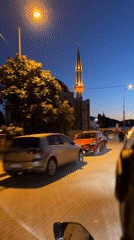 Nighttime street scene captured near illuminated mosque construction in Fethiye