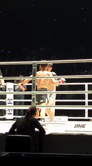 Boxing match underway in Bangkok ring between two fighters