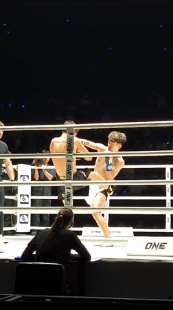 Boxing match underway in Bangkok ring between two fighters