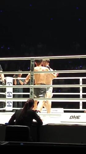 Boxing match underway in Bangkok ring between two fighters