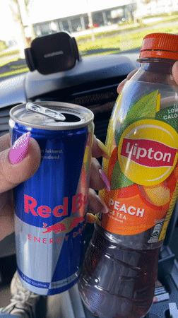 Driver holds energy drink and iced tea in Dronten