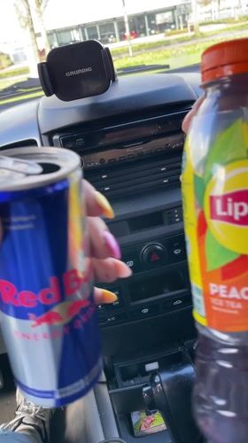 Driver holds energy drink and iced tea in Dronten