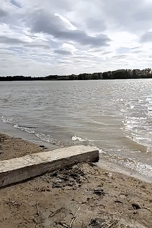 Concrete block observed on sandy shore in Pavlodar