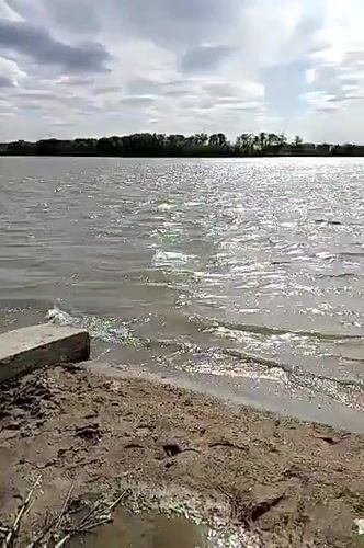 Concrete block observed on sandy shore in Pavlodar