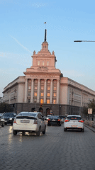 Evening street activity documented around Sofia's National Assembly building