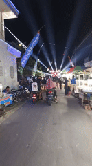 Night market energy along lit streets in East Java