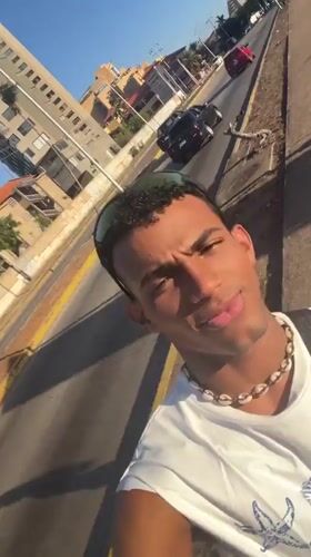 Young man films selfie video on Porlamar streets
