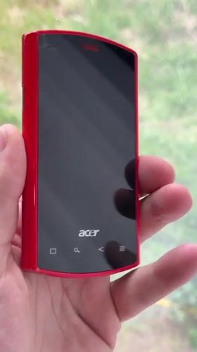 Person holds red Acer phone in Chuprino, Russia