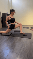Three people practice yoga in fitness studio