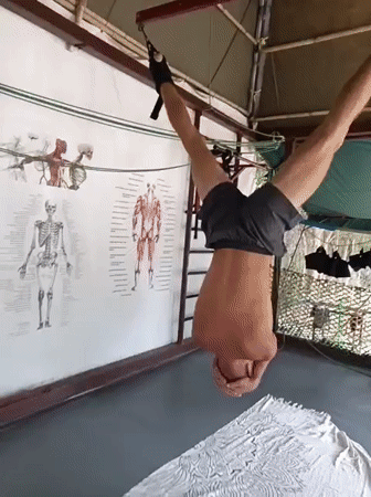 Inverted ankle hang at a Nha Trang outdoor gym