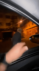 Nighttime street conversation and kitten feeding captured in Safi