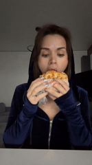 Person enjoys sandwich meal in Лобаново, Russia