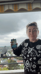 Woman displays tarot cards on balcony in Waiblingen