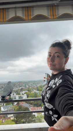 Woman displays tarot cards on balcony in Waiblingen