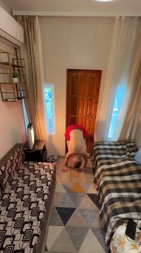 Man performs handstand in bright room in Gelendzhik