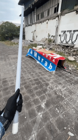 Person with white tube observed in derelict Kuta area