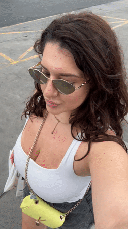 Woman films selfie on Patong sidewalk early morning