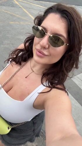 Woman films selfie on Patong sidewalk early morning
