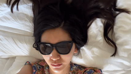 Woman resting on bed observed in Grimaud, France