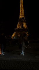 Evening activity captured near illuminated Eiffel Tower in Paris