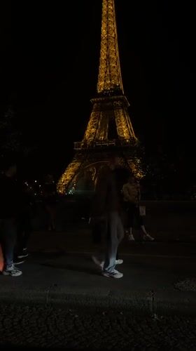 Evening activity captured near illuminated Eiffel Tower in Paris